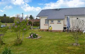 a house with a yard with flowers in the grass at Gorgeous Home In Marcillac-La-Croisille in Marcillac-la-Croisille +5 photos