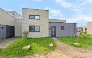 a brick house with rocks in the yard at Amazing Home In Lembruchdümmer See in Lembruch