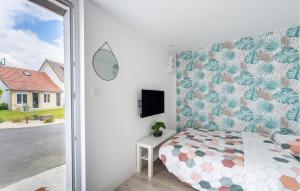 a bedroom with a bed and a tv on a wall at Stunning Apartment In Amblainville in Amblainville