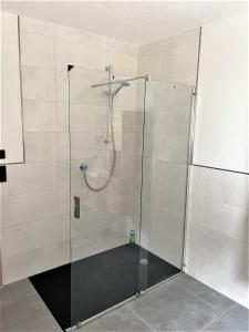 a shower with a glass door in a bathroom at Zwiesler Haus Bschlabs in Bschlabs