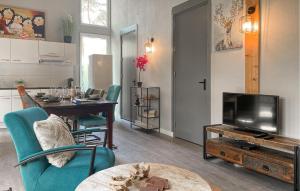 a living room with a table and a television at Lovely Home In Meijel With Wifi in Meijel