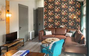 a living room with a couch and a table at Lovely Home In Meijel With Wifi in Meijel +10 photos