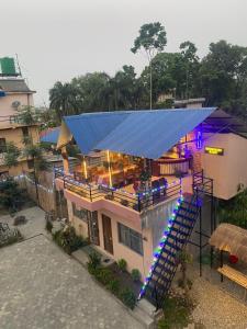 an overhead view of a house with a blue roof at Hotel Safari Suite in Sauraha
