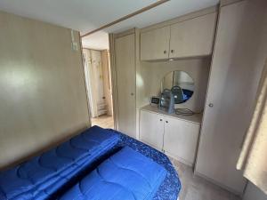 Un pequeño dormitorio con una cama azul. en Bospark Lunsbergen - LB 50, en Borger