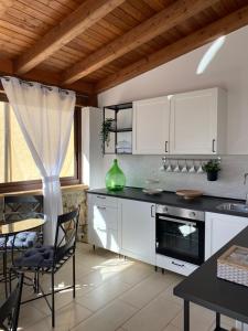 een keuken met witte kasten en een tafel met stoelen bij B&B Villa Da Antonio in Caltanissetta