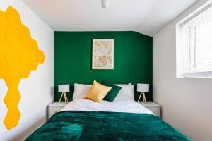 a bedroom with green and white walls and a bed at 4 Bed House Contractor & Leisure in Preston