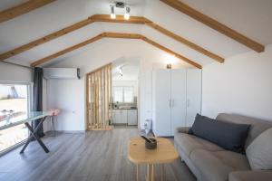 a living room with a couch and a table at Studio Luca Christo in Mrzenci