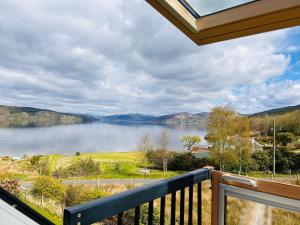 a view of a lake from the balcony of a house at The Cottage, overlooking Loch Fyne in Cairndow