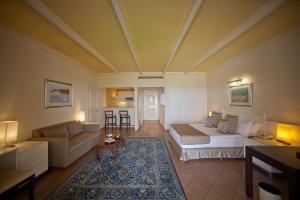 a living room with a bed and a couch at Le Royal Hotel - Beirut in Beirut