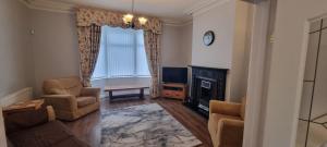 a living room with a fireplace and a television at Traditional 3-Bed House on the Historic Headland in Hartlepool