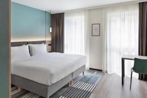 a hotel room with a bed and a desk and a bed at Residence Inn by Marriott Hamburg Altona in Hamburg