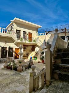 a large house with a staircase in front of it at Nomad inn in Sanlıurfa