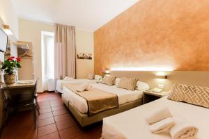 Postel nebo postele na pokoji v ubytování Albergo Firenze