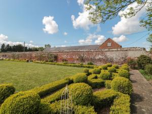 a hedge garden in front of a brick building at Buckland House Annex in Taunton