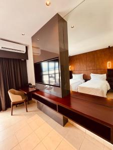 a bedroom with a large bed and a large mirror at Lamana Hotel in Port Moresby