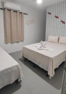 a hospital room with a bed and a table with plates on it at Pousada Mandakaru in Maragogi