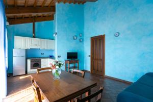 a living room with a table and a blue wall at Il Podere Del Germano Reale in Coriano