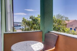 a table and chairs on a balcony with a view of the ocean at House MARISSA by the sea with sea view in Nerezine