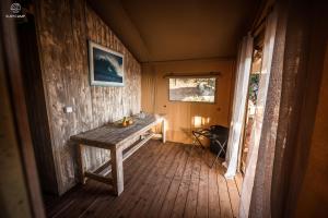 a wooden table in the corner of a room at Oasis Camp Portugal in Lagoa