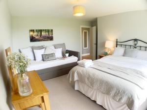 a bedroom with two beds and a table at Rowlands Annex in Yelverton