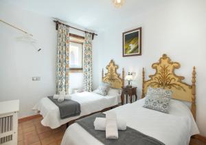 a bedroom with two beds and a window at Owl Booking Villa Rafals - Wonder in the Midst of Nature in Pollença