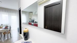 a door on a wall in a kitchen with a table at Esperia Apartment by Ca-Sa Check in Chioggia