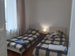 two beds sitting next to each other in a room at Tilda&Matilda in Kutaisi
