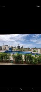 a view of a swimming pool and a building at Apartament litoral norte NatalRN in Natal