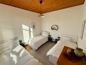 1 Schlafzimmer mit 2 Betten und Holzdecke in der Unterkunft Ferienhaus mit Garten im Herzen von Lacanau-Océan in Lacanau-Océan