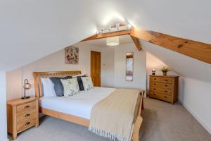 a bedroom with a large bed with a wooden headboard at Esk Valley House in Sleights