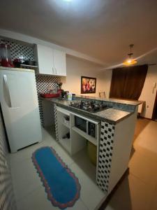 uma cozinha com um fogão e um tapete azul em Apartamento Com Piscina no Rio de Janeiro