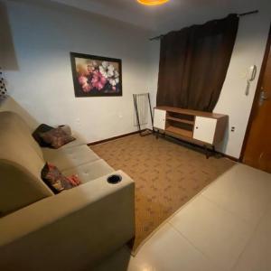 uma sala de estar com um sofá e uma cómoda em Apartamento Com Piscina no Rio de Janeiro