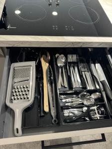a drawer filled with utensils in a cabinet at Apartament w Centrum Tarnowa Lwowska in Tarnów