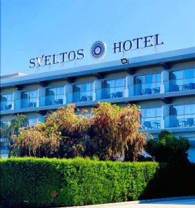 a hotel with a sign on the side of it at Sveltos Hotel in Larnaca