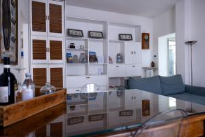 a living room with a couch and a glass table at Boutique Apartment Cà Monastero in Verona