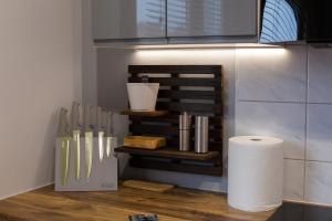 a kitchen with a counter with knives and a roll of paper towels at Dwupokojowy Apartament 700 m od Szpital Prokocim in Kraków +5 photos