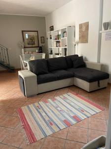 a living room with a couch and a rug at FINESTRA SUL MARE in Palermo