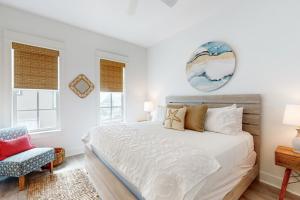 a bedroom with a large bed and a chair at Fairway Sunsets in Port Aransas