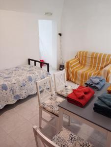 a bedroom with a bed and a table and chairs at Casa Mariella in Bari