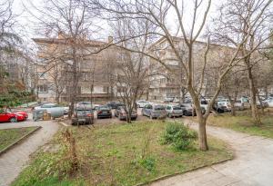 a parking lot with cars parked in front of a building at Top Location Central New & Spacious 3 BDR apt Medical Academy in Sofia