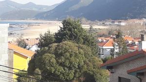 a view of a city with a mountain in the background at Hostería La Casona in Noja