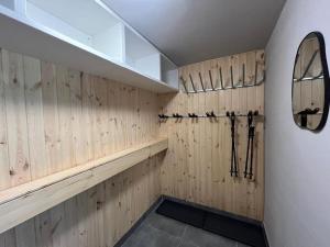 a bathroom with wood paneled walls and a mirror at Widokowe Wzgórze - Sun&Sport in Szczyrk