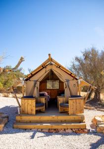 a tent with a bed and chairs in it at Oasis Camp Portugal in Lagoa +10 photos