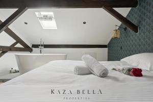 a bedroom with a white bed with two towels on it at KAZA BELLA - Maisons Alfort 3 Modern flat in Maisons-Alfort