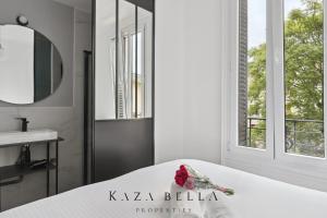 a bedroom with a bed and a sink and a window at KAZA BELLA - Maisons Alfort 3 Modern flat in Maisons-Alfort
