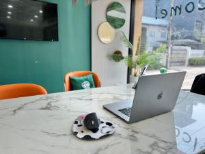 a laptop computer sitting on top of a table at Pentafield City Residence in Amphoe Phra Khanong