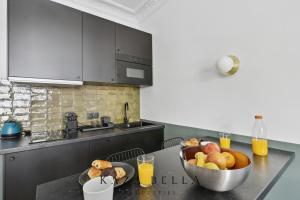 a kitchen with a bowl of fruit on a table at KAZA BELLA - Maisons Alfort 3 Modern flat in Maisons-Alfort