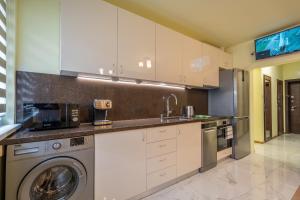 a kitchen with white cabinets and a washer and dryer at Top Location Central New & Spacious 3 BDR apt Medical Academy in Sofia