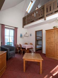 a living room with a table and a dining room at Apartment 15 - Ferienresidenz Roseneck, Galeriewohnung, mit Schwimmbad in Todtnauberg bei Feldberg in Todtnauberg