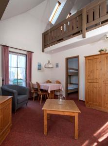 a living room with a table and a dining room at Apartment 15 - Ferienresidenz Roseneck, Galeriewohnung, mit Schwimmbad in Todtnauberg bei Feldberg in Todtnauberg +20 photos